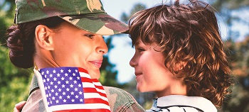 Mom soldier looks at his son with a smile