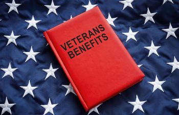 Veterans Benefits book on a national flag.